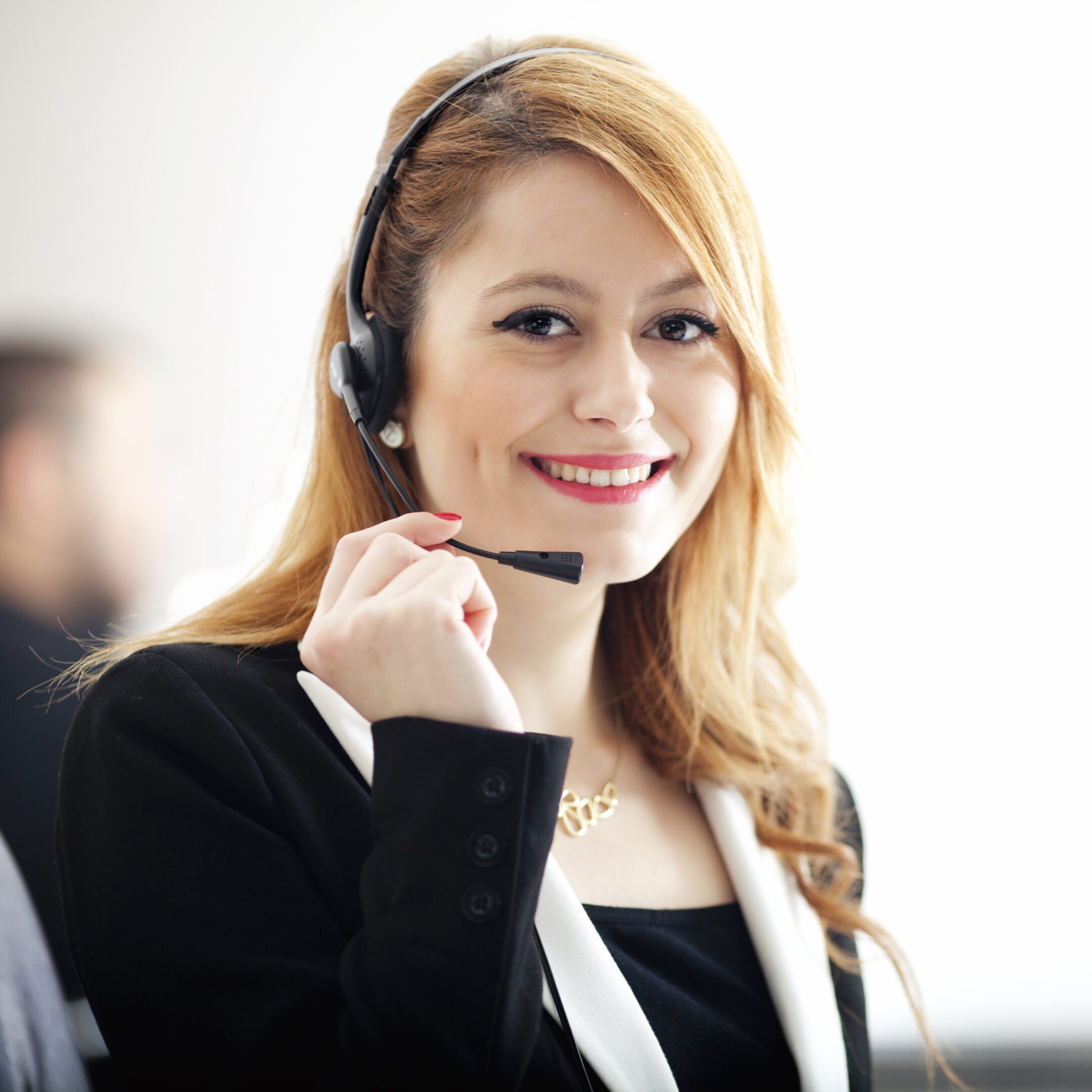 Smiling woman wearing a headset, working.